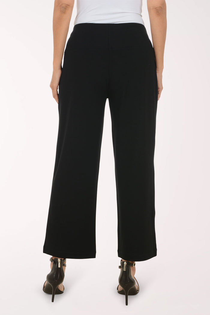 Woman wearing black full length pants