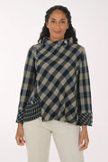 Woman wearing a black and white plaid mock neck top
