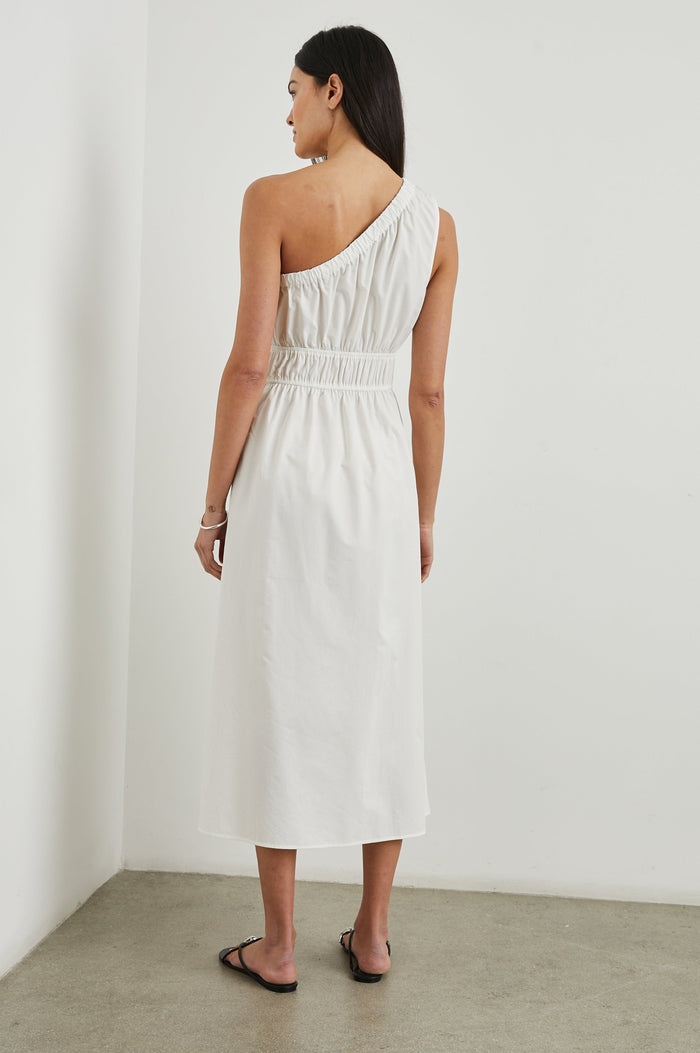 Selani Midi Dress With an Asymmetrical Neckline, Mid-Thigh Slide Slit and Cinched Waistband in White Colorway - Back Full Body View Featured on Model